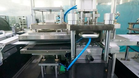 Base film thermoforming and cooling device